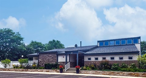a brick building with blue windows and a parking lot
